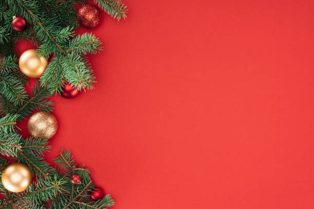 istock flat lay with pine tree branches with red and golden christmas balls isolated on red 1059177630