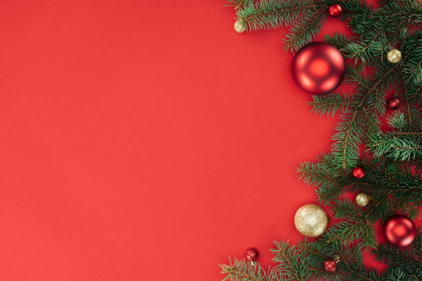 istock flat lay with pine tree branches with red and golden christmas balls isolated on red 1059177652