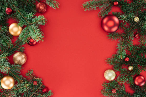 istock flat lay with pine tree branches with red and golden christmas balls isolated on red 1059177692