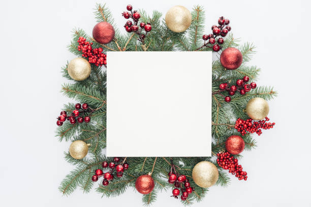 istock top view of pine tree wreath with Christmas decorations and square blank space in middle isolated on white 1059177902