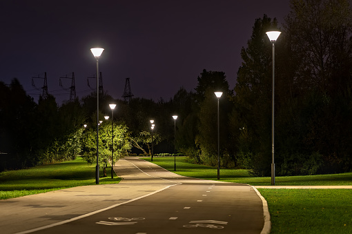 Road view at dusk, straight row of street lights, traffic. Galicia, Spain