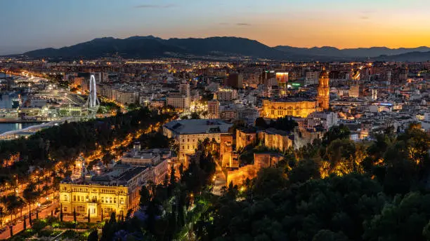 Aerial panoramic view of Malaga city, Andalusia, Spain after beautiful sunset