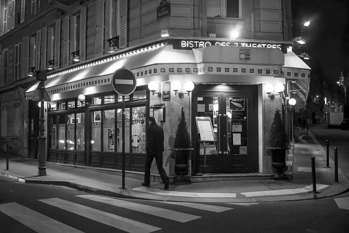 Paris, France,11/27/2016,bistro des teatres, paris. A man passes through a sidewalk, a restaurant in Paris