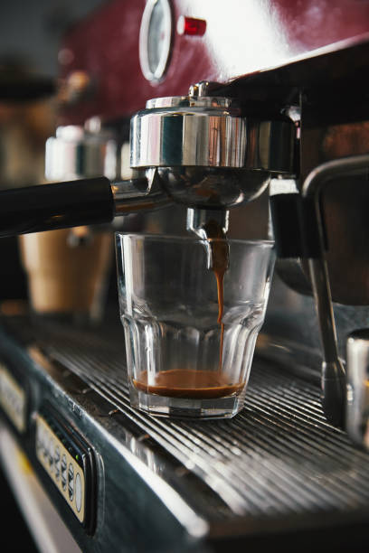 istock professional coffee maker and glass cup with espresso in coffeehouse 1059197032