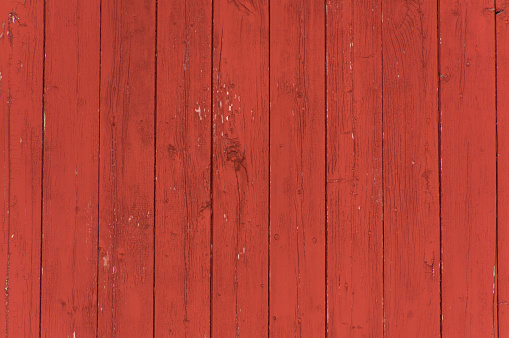 Vertical oxblood red barn door boards and planks background.  Barnboard planks, running vertically.