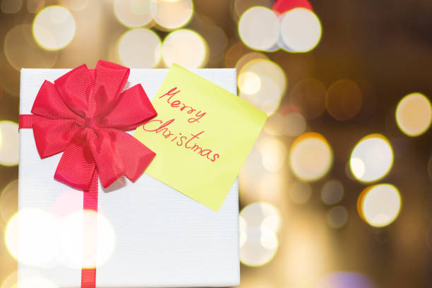 istock Gift Box and Christmas Cards on Bokes Background. 1059202904