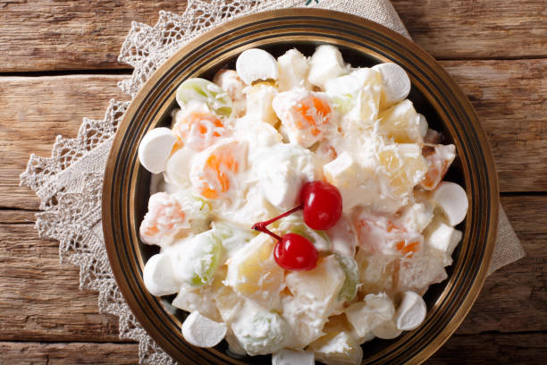istock Light fruit salad Ambrosia with marshmallow and vanilla yogurt close-up. horizontal top view 1059203522