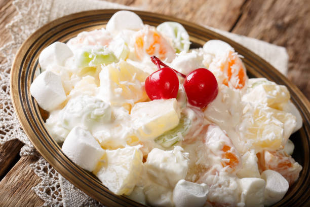 istock Light fruit salad Ambrosia with marshmallow and vanilla yogurt close-up. horizontal 1059204838