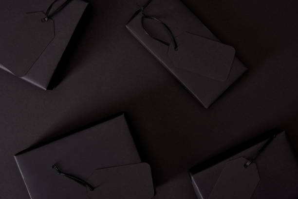 istock top view of black boxes with tags on black surface, black friday concept 1059205780