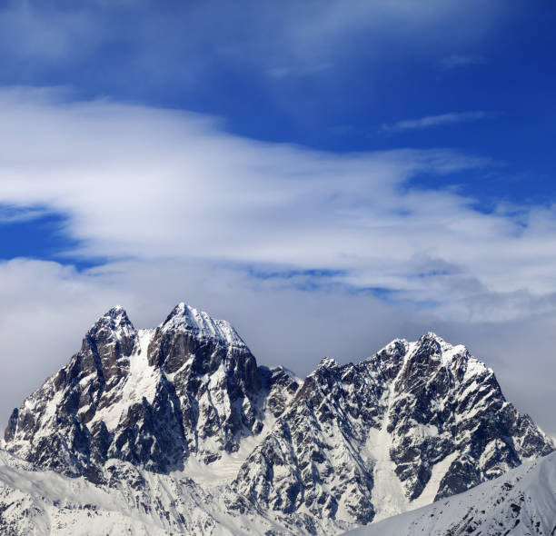istock Mounts Ushba and Chatyn and blue sky with clouds 1059207794