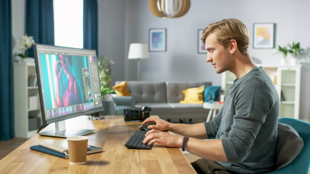 istock Professional Photographer Works in Photo Editing App / Software on His Personal Computer. Photo Editor Retouching Photos of Beautiful Girl. Mock-up Software Design. 1059208458