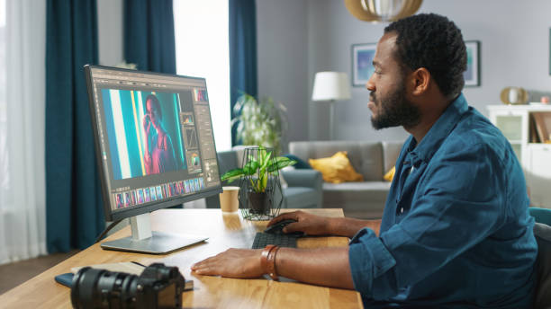 istock Professional Photographer Works in Photo Editing App / Software on His Personal Computer. Photo Editor Retouching Photos of Beautiful Girl. Mock-up Software Design. 1059208504