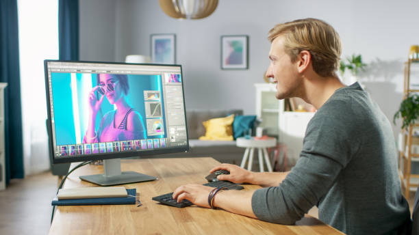 istock Professional Photographer Works in Photo Editing App / Software on His Personal Computer. Photo Editor Retouching Photos of Beautiful Girl. Mock-up Software Design. 1059208506