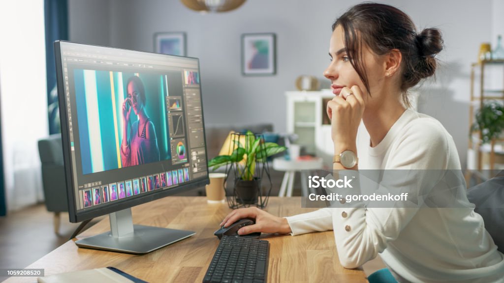 Professional Female Photographer Works in Photo Editing App / Software on His Personal Computer. Photo Editor Retouching Photos of Beautiful Girl. Mock-up Software Design. Graphic Designer Stock Photo