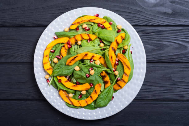 istock Autumn salad with pumpkin , spinach , pomegranate and chickpea 1059214486