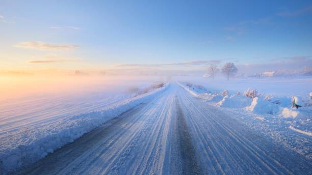 istock Fog over a snowcovered rural highway during winter sunset 1059215028