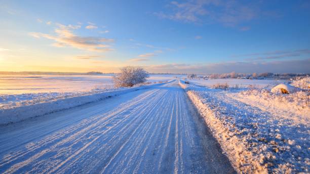 istock Snowcovered rural highway during winter sunset 1059215044