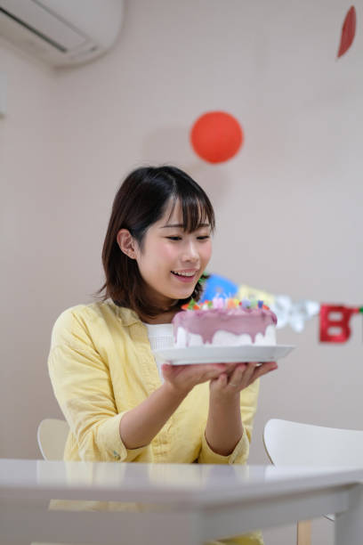 Woman preparing for birthday cake