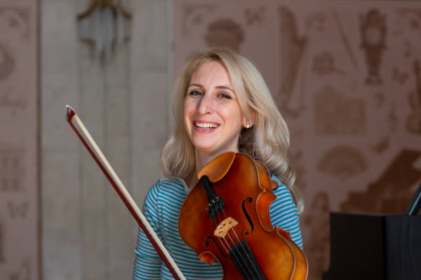 istock Young positive blonde playing violin 1059217960