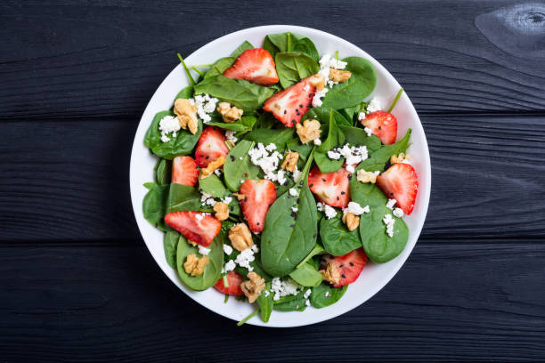 istock Strawberry salad with spinach , cheese and walnut 1059223418