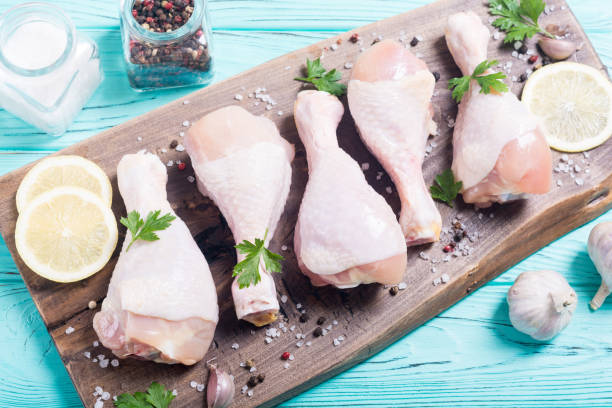 istock Raw chicken legs with spices and parsley 1059223770