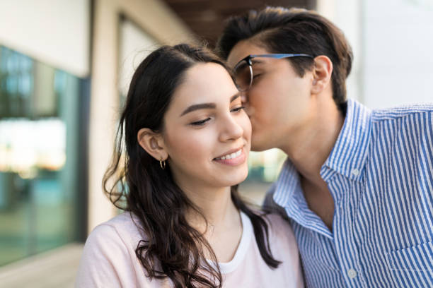 istock Cute Man Kissing Girlfriend On Cheek 1059224094