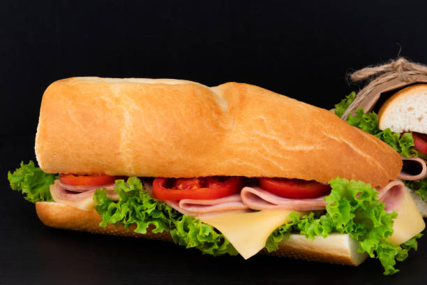 istock sandwich with with ham, cheese, tomatoes, lettuce on over stone 1059224366