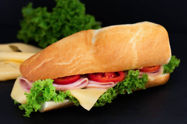 istock sandwich with with ham, cheese, tomatoes, lettuce on over stone 1059224476
