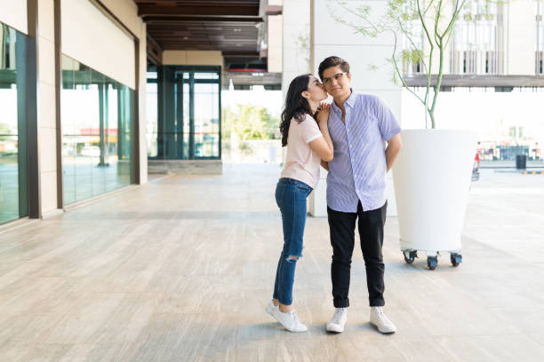 istock Girlfriend Standing On Tiptoes To Kiss Partner 1059224596