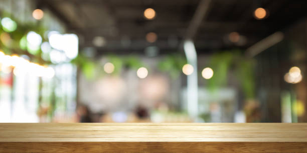 istock Empty wooden table top with blur coffee shop or restaurant interior background, Panoramic banner. 1059228870
