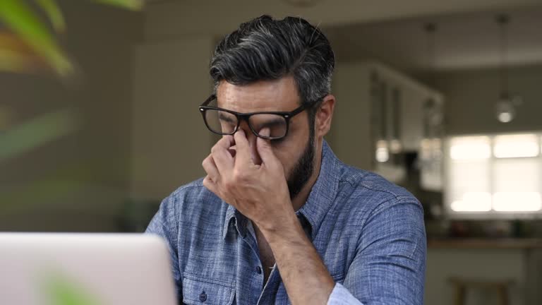 Stressed middle eastern man working at computer