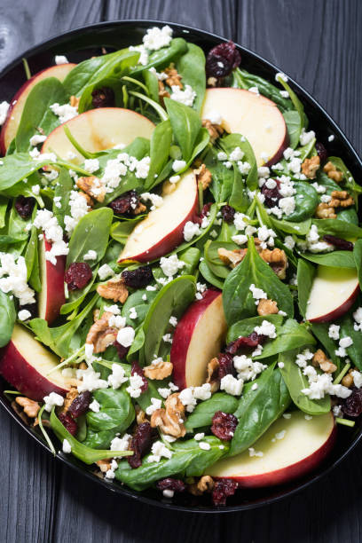 istock Autumn spinach salad with apple , cheese , walnut and dried cranberry 1059233196