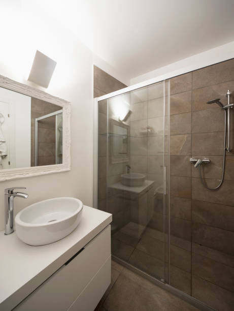 istock Elegant bathroom with dark tiles 1059236682