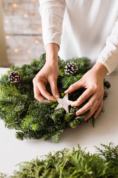 istock Unrecognizable woman decorating christmas wreath. 1059240448