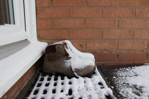 istock Snowy boots on the doorstep 1059243876