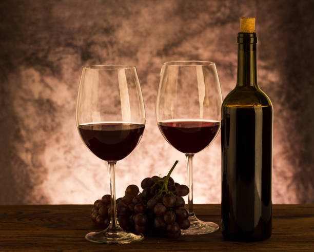 istock Wine bottle with glasses and grapes on table 1059245156