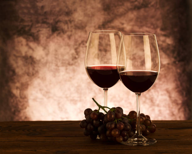 istock Wine glasses with grapes on table. Red wine 1059245162