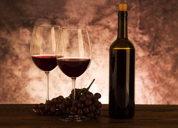 istock Wine bottle with glasses and grapes on table 1059245396