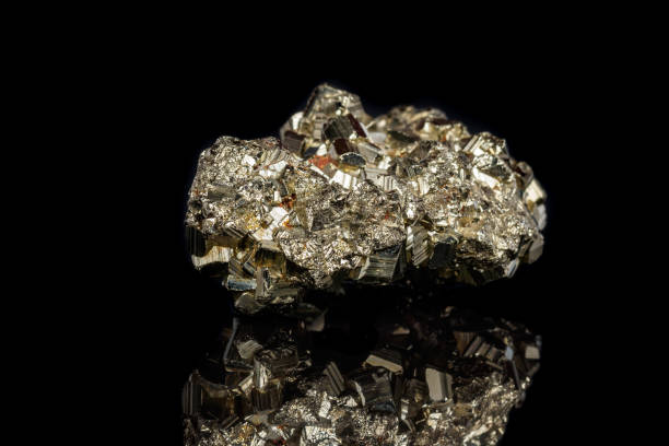 istock Macro mineral stone Pyrite on a black background 1059250442
