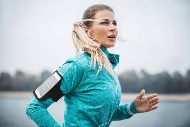 istock Woman running by the lake 1059250908