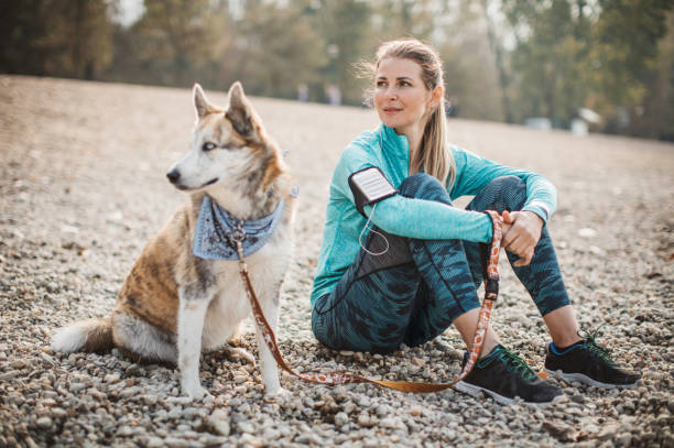 istock Woman resting on beach with dog 1059250982