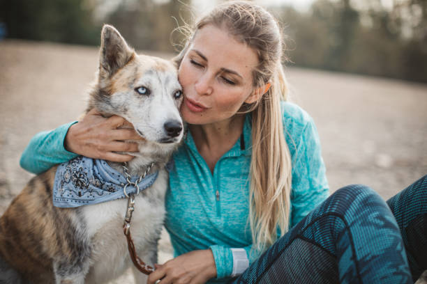 istock Woman resting on beach with dog 1059251060