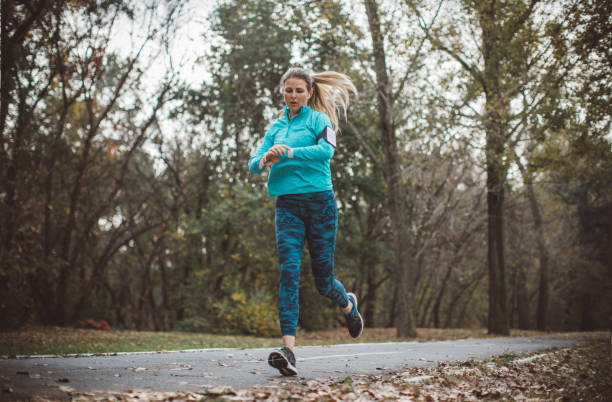 istock Woman running in forest 1059251290