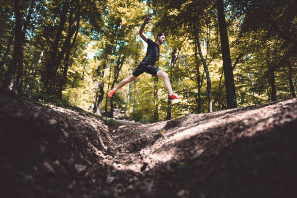 istock Young athlete jumping in the forest 1059254406