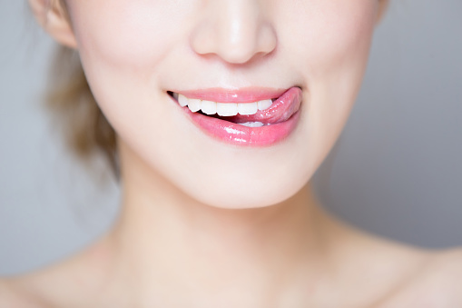 close up of beauty woman teeth and tongue