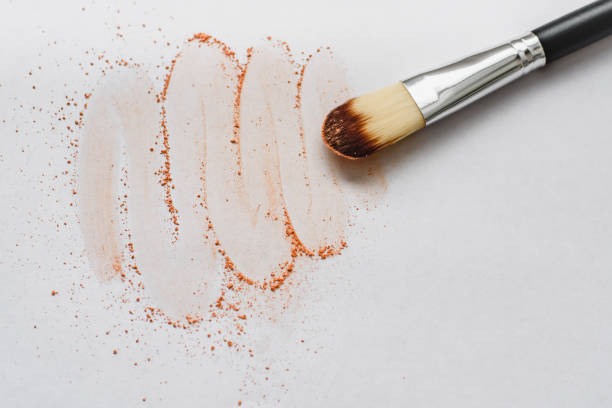 istock Makeup brush with beige powder isolated on white background. Makeup artist tool. 1059257500