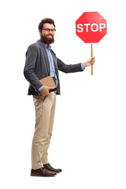 istock Man holding books and stop sign 1059259532