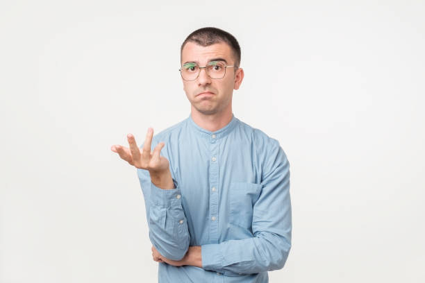 istock Nervous doubtful male frowning his eyebrow having puzzled look going to make serious decision. 1059260352