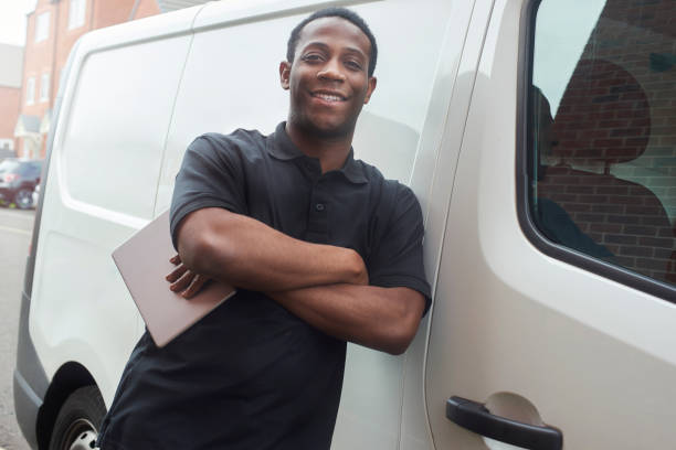 istock Smiling tradesman stood at van 1059260744