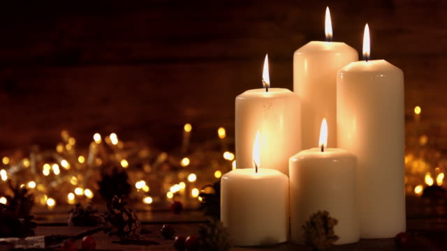 hristmas composition with burning white candles and stars ornaments